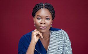 Pictured against a maroon background: Aanuoluwapo Annie Ojewunmi - The Airplane Girl