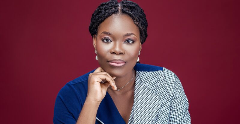 Pictured against a maroon background: Aanuoluwapo Annie Ojewunmi - The Airplane Girl
