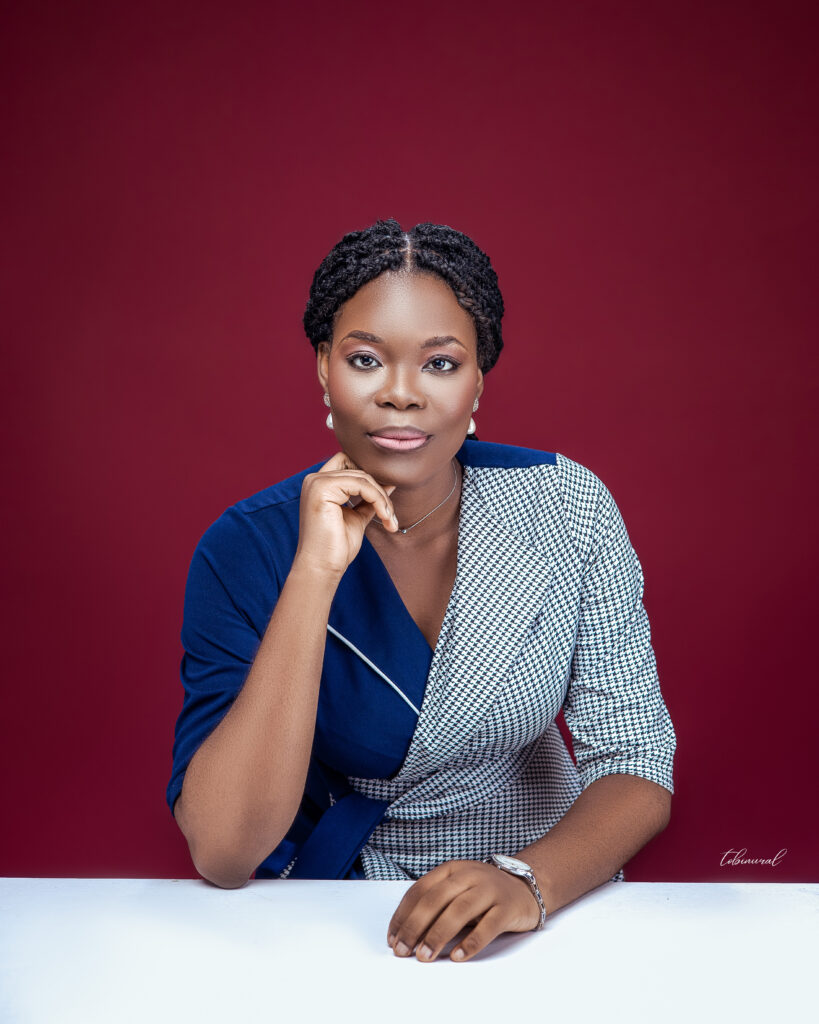 Pictured against a maroon background: Aanuoluwapo Annie Ojewunmi - The Airplane Girl