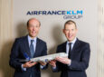 Air France-KLM and SAS executives posing for a photo with an aircraft model in celebration of the acquisition.