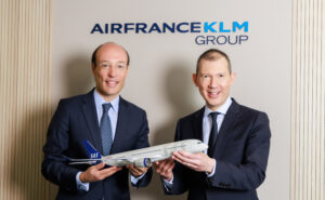 Air France-KLM and SAS executives posing for a photo with an aircraft model in celebration of the acquisition.