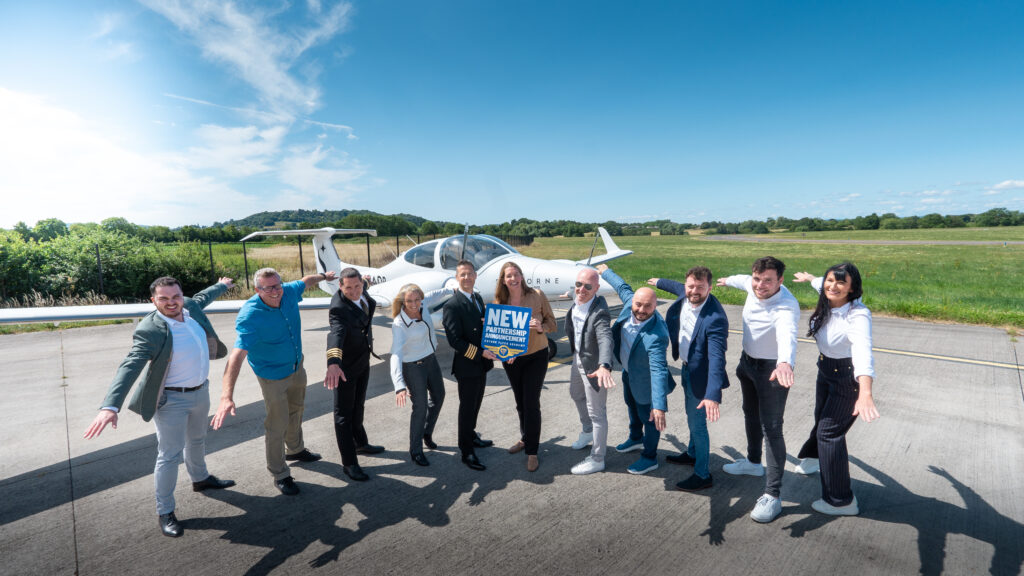 Skyborne training staff in front of a light aircraft.