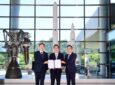 Hanwha and KARI executives pose for a picture after signing.
