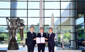 Hanwha and KARI executives pose for a picture after signing.
