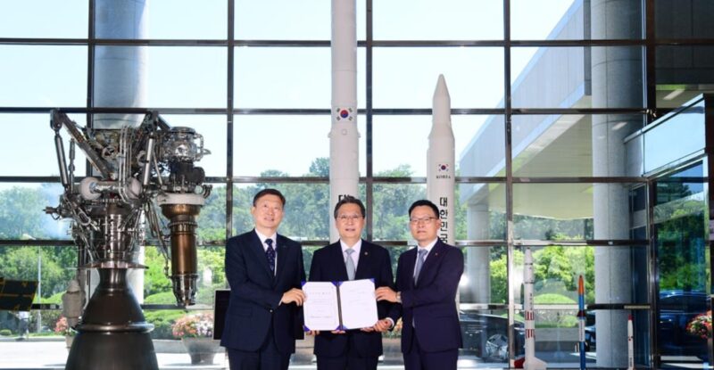 Hanwha and KARI executives pose for a picture after signing.