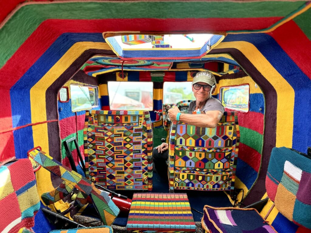 Ralph Ziman sitting inside the aircraft. The interior is just as colorful as the exterior.