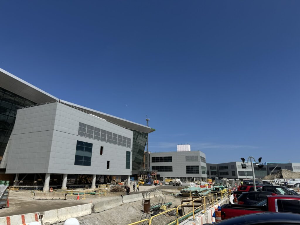 Outside the New Terminal One at JFK, whilst it is under construction on a blue sky day.