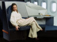 A female passenger is sitting in the Stelia OPERA ESSENTIAL seat