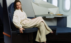 A female passenger is sitting in the Stelia OPERA ESSENTIAL seat