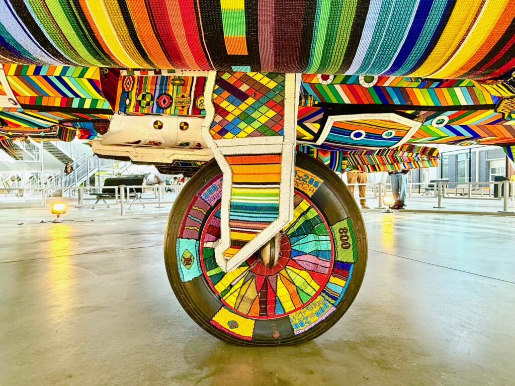 The wheel of the aircraft is adorned with colorful beading.