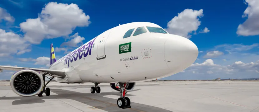 flyadeal A320neo parked on a sunny day