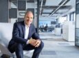 Lars Wagner is sitting on a chair in the Airbus offices for a photo.