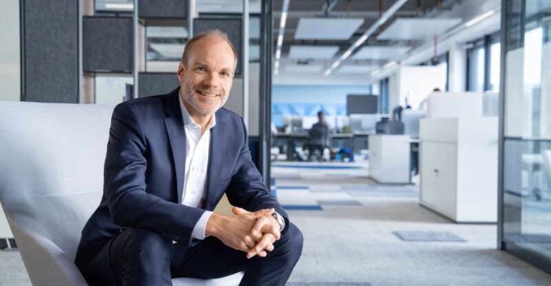 Lars Wagner is sitting on a chair in the Airbus offices for a photo.