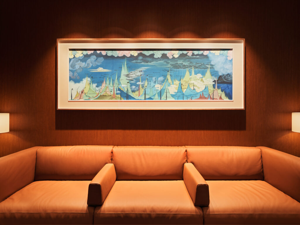 Beautiful artwork sits above a sofa.