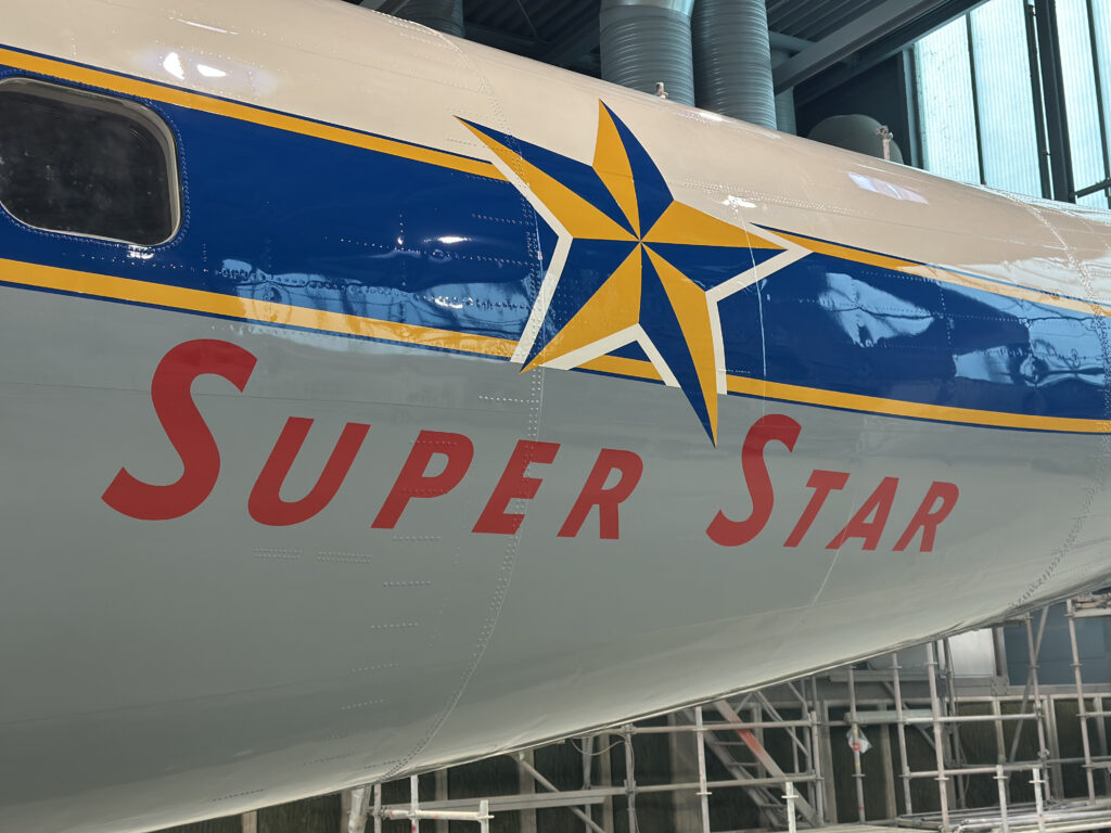 The words Super Star are painted in red on the side of the aircraft's fuselage