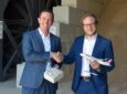 SWISS and neustark executives shake hands