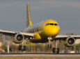 Spirit Airlines A320, in the carrier's signature yellow and black livery, on landing.