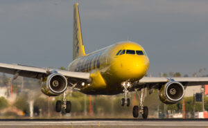 Spirit Airlines A320, in the carrier's signature yellow and black livery, on landing.