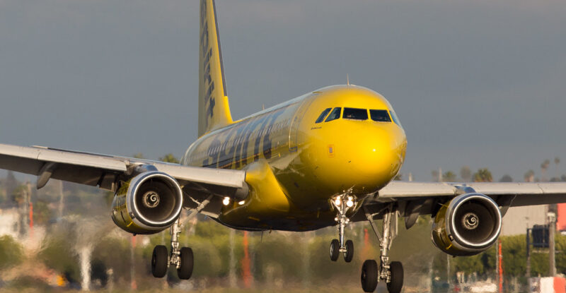 Spirit Airlines A320, in the carrier's signature yellow and black livery, on landing.