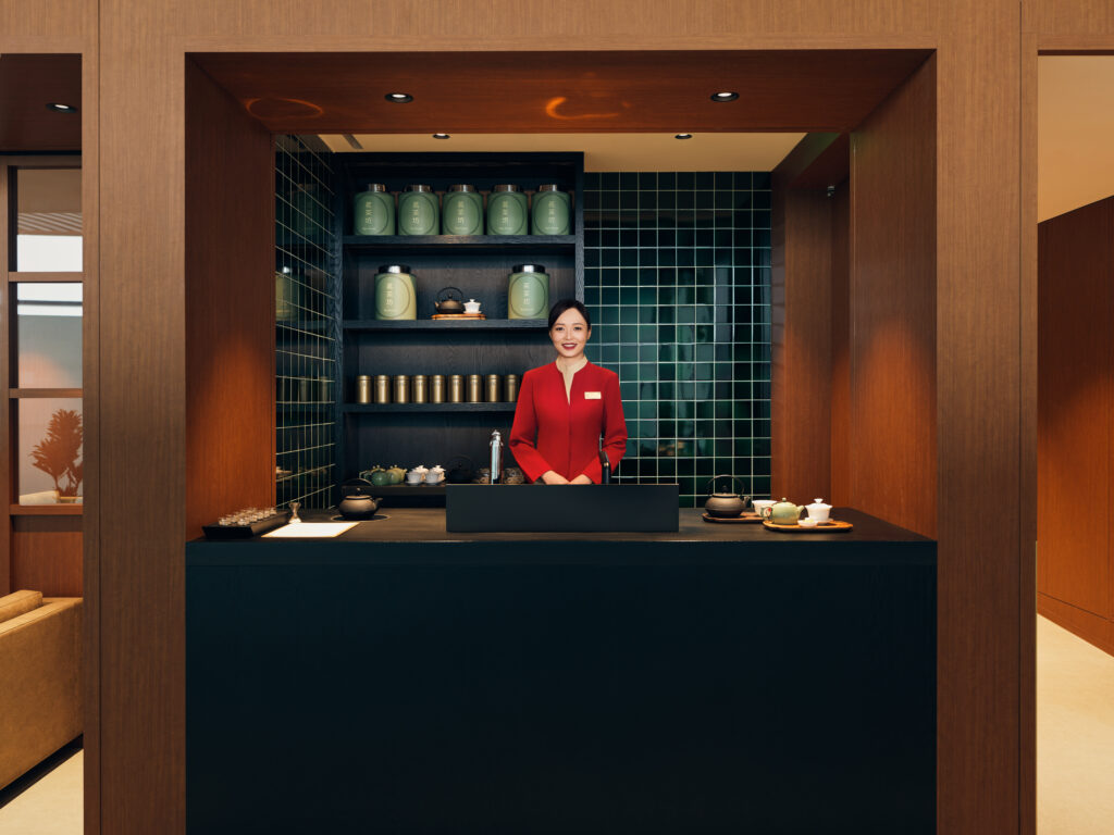 A Cathay Pacific crew member welcoming guests