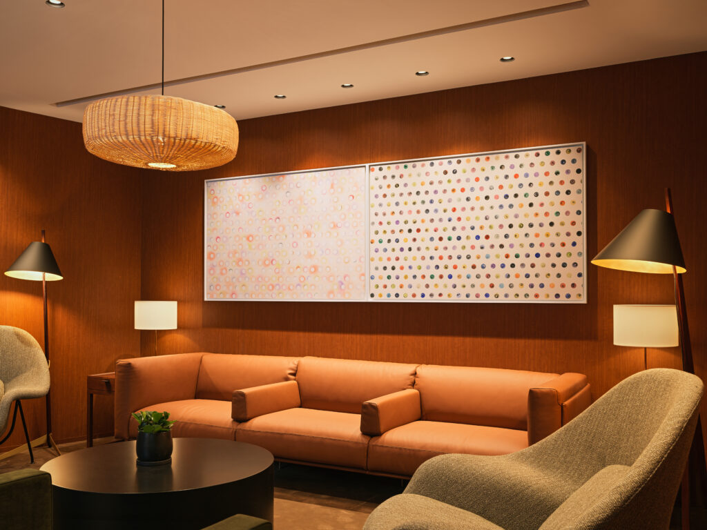 Cathay Pacific redesigned lounge experience at Beijing Capital International Airport with art decorated walls and various types of seating.