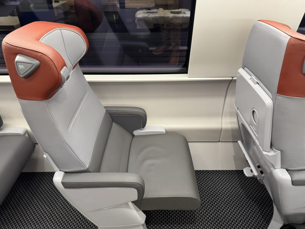 The train seat is in recline position. 