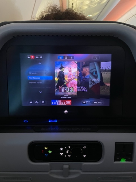 Wicked is among the titles shown on the IFE screen.