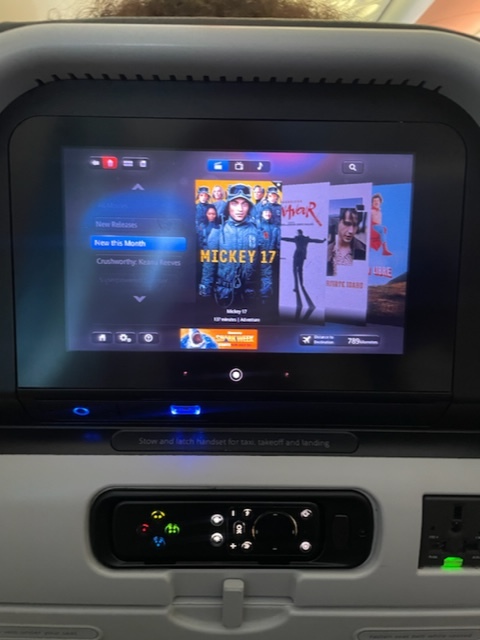 The author selects Mickey 17 to view on the IFE screen.
