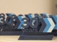 The words "Lufthansa Systems 30 years" are seen in block letters on a table