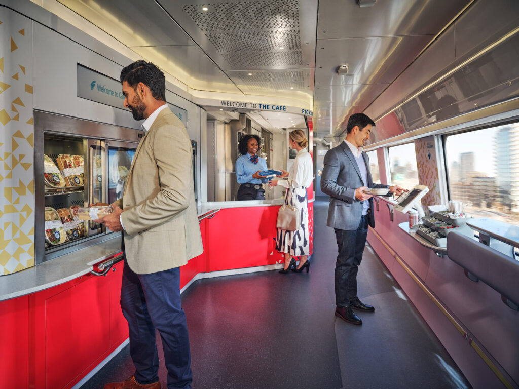 Passengers are standing in the cafe, which lacks seating