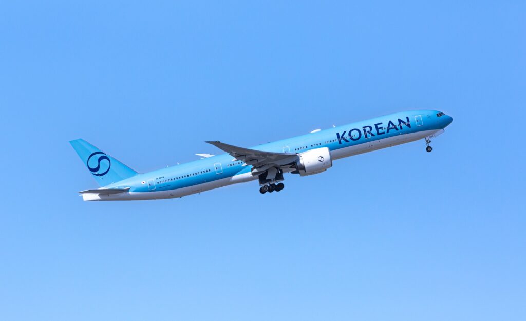 Korean 777 in-flight on a blue sky day