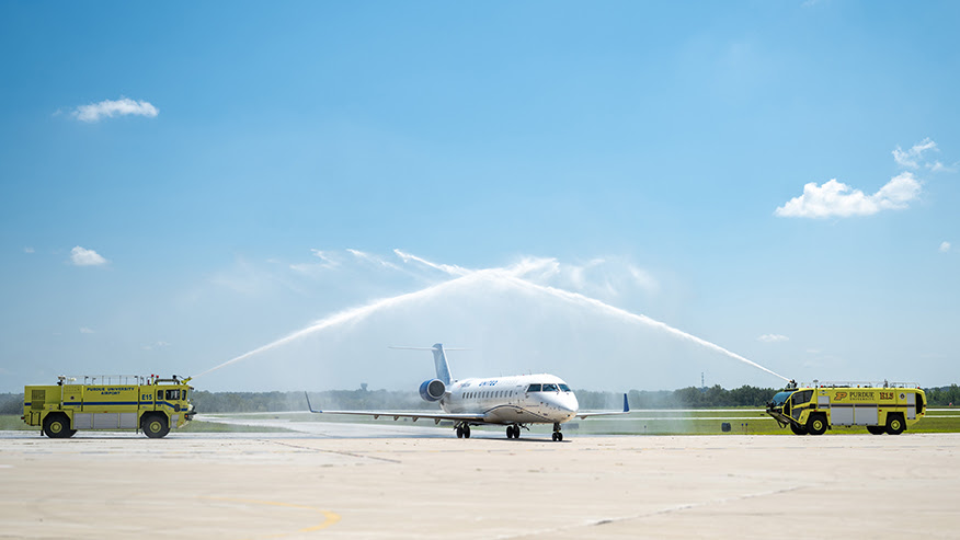 The Purdue University Fire Department provides a water cannon salute Friday (Aug. 8) as a plane taxis down the runway at a ceremony marking the opening of the new Amelia Earhart Terminal at the Purdue University Airport. (Purdue University photo/Kelsey Lefever)