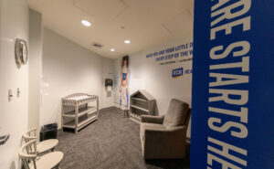 Inside an Ontario International Airport nursing station. A baby-changing table is in view, as is a comfy recliner.