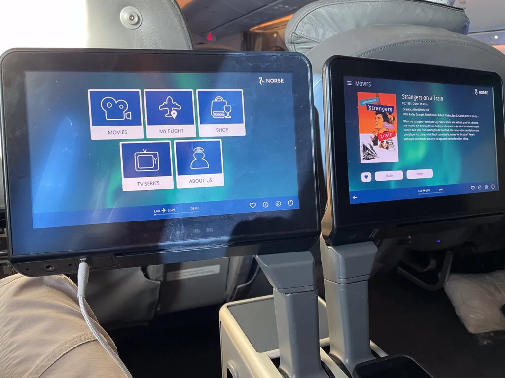 Two IFE screens displaying content options for inflight entertainment. 