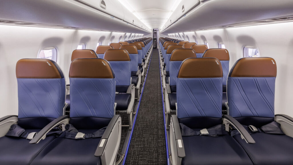 American Airlines' 2-2-configured E175 cabin interior with blue seats and brown headrests.