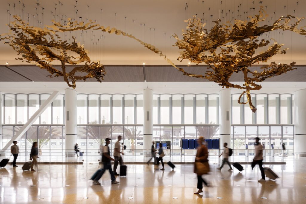 The lobby of San Diego International Airport is adorn with art installations and high windows allowing lots of natural light.