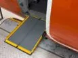 A Portaramp ramp is positioned between the aircraft and the jet bridge to ensure an easier boarding experience for the Disabled passenger