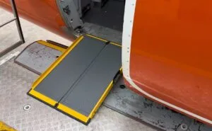 A Portaramp ramp is positioned between the aircraft and the jet bridge to ensure an easier boarding experience for the Disabled passenger