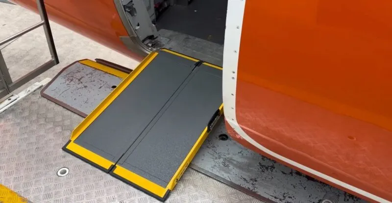 A Portaramp ramp is positioned between the aircraft and the jet bridge to ensure an easier boarding experience for the Disabled passenger
