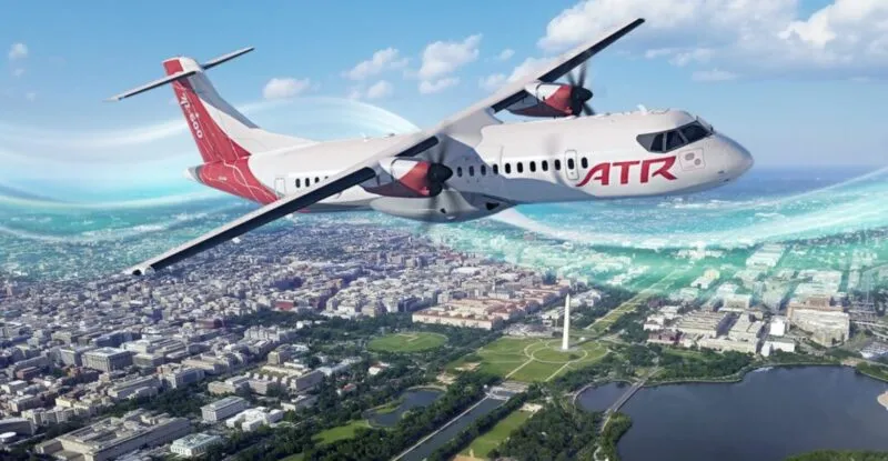 Rendering of ATR turboprop in flight over a city.