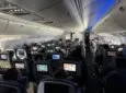 A view from the rear of the Delta 767-400 cabin with virtually all the IFE screens being used