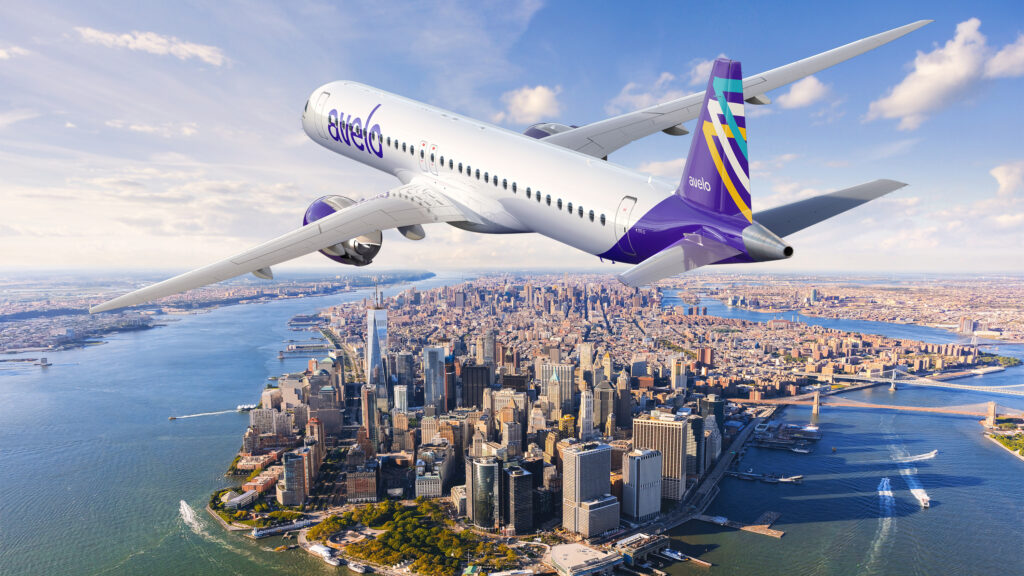 Rendering of E2 in Avelo livery flying over a city