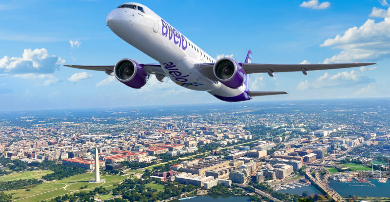 Rendering of E2 in Avelo livery flying over a town and a body of water