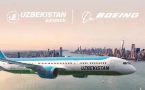 Uzbekistan Airways Dreamliner flying over a city.