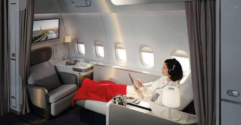 A passenger is lounging in the La Première suite.