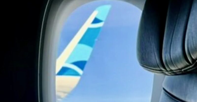 JetBlue wingtip as seen through cabin window