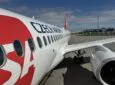Czech Airlines branded Airbus A220-300 parked at the gate for Smartwings passengers