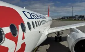 Czech Airlines branded Airbus A220-300 parked at the gate for Smartwings passengers