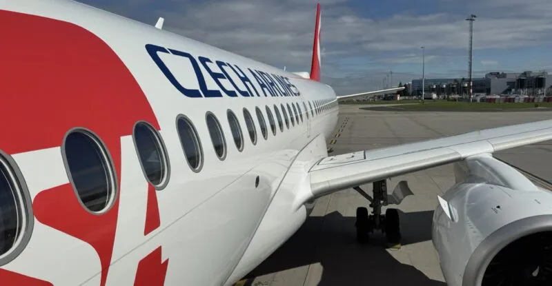 Czech Airlines branded Airbus A220-300 parked at the gate for Smartwings passengers