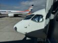 Czech Airlines branded Airbus A220-300 parked at the gate for Smartwings passengers. A Smartwings branded aircraft is in the background.